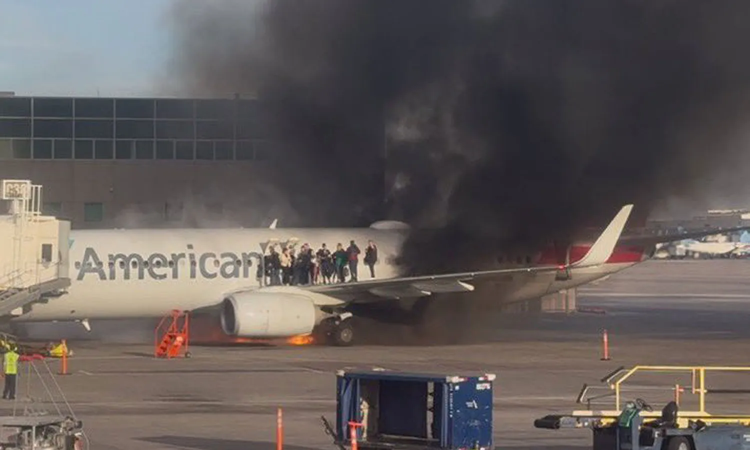 American's Boeing 737-800 catches fire as passengers wait for rescue on the left wing (Social media)